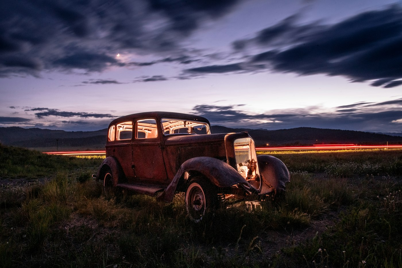 Older unused car parked outdoors